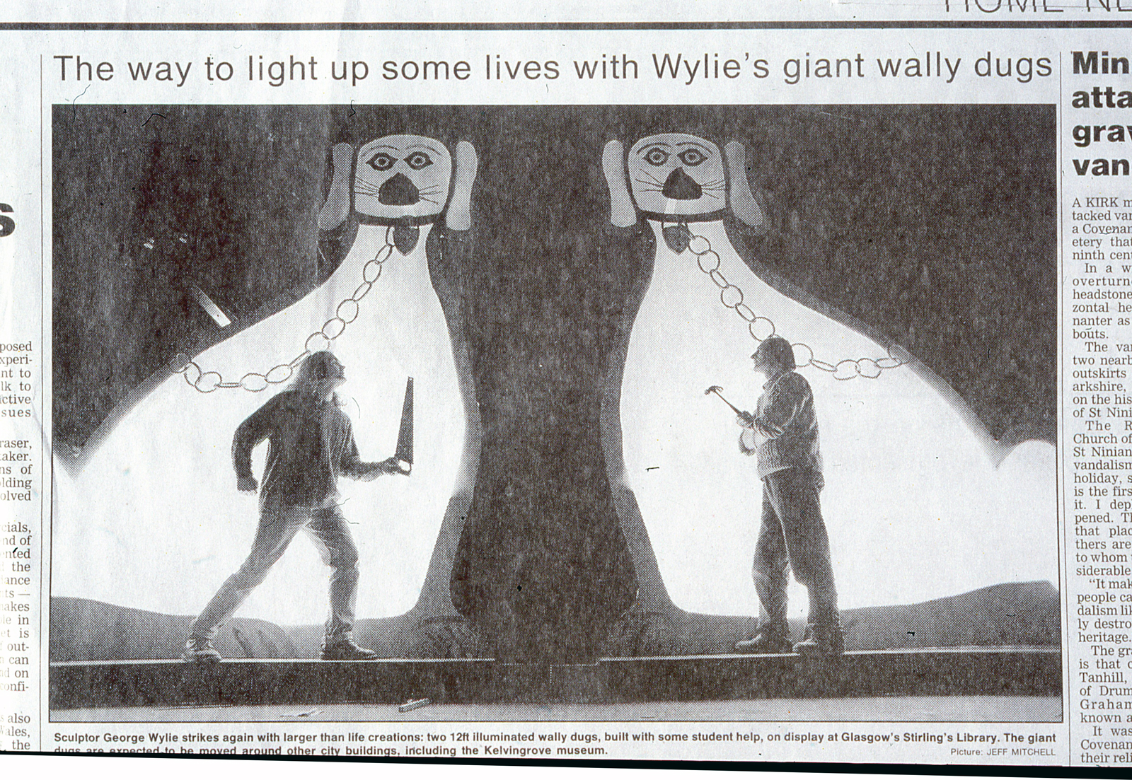 Cutting from the Herald newspaper - photo of laminated Wally Dug sculptures with two people standing.